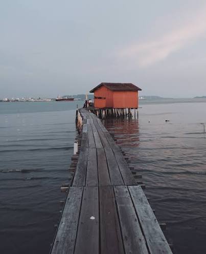 Lantern-lit wooden walkway at the clan jetties in George Town after dark