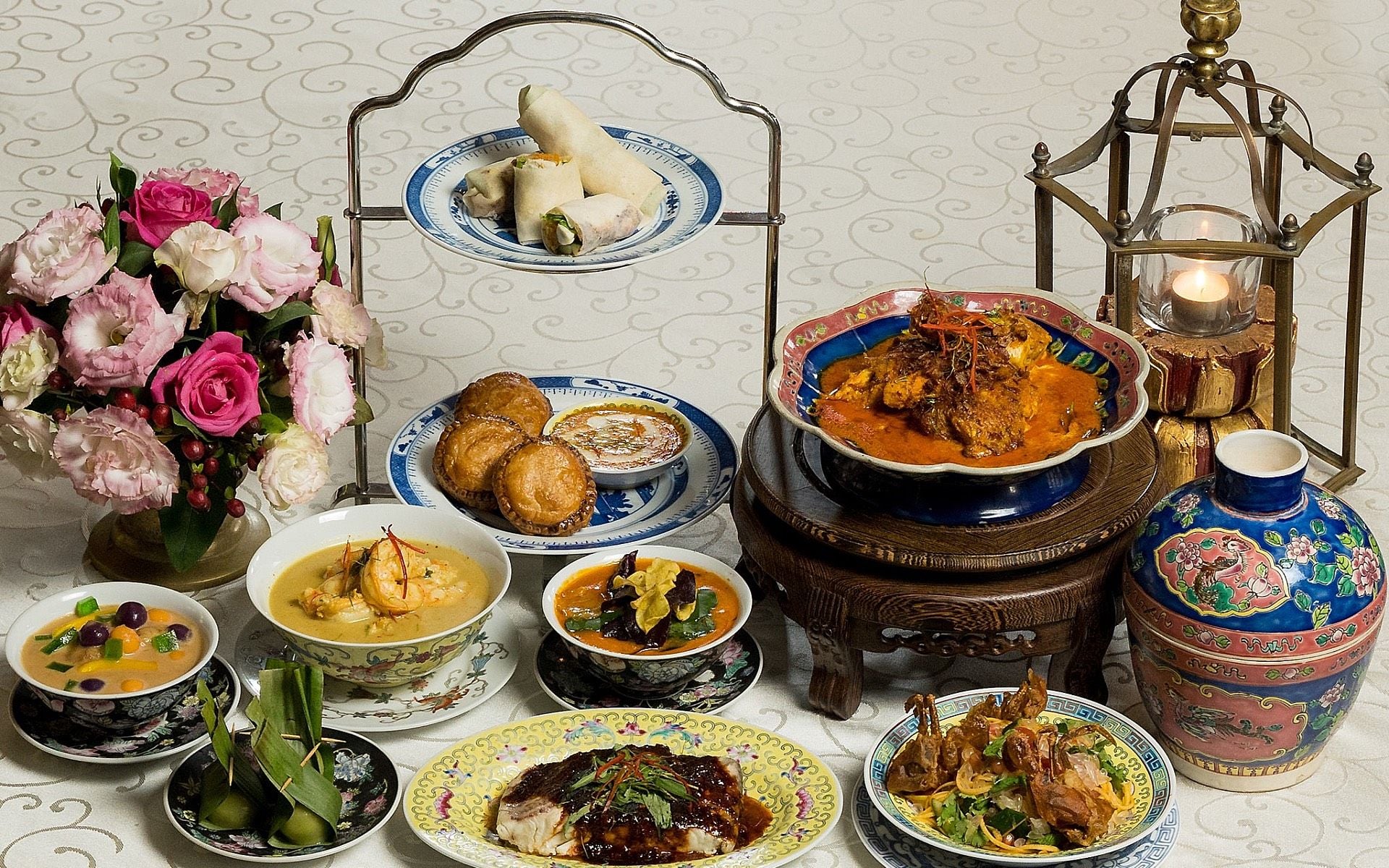Spread of Penang dishes including nasi kandar, Nyonya laksa and char-grilled fish at a George Town restaurant